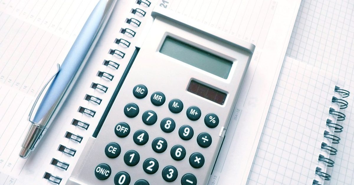 Calculator and pen on a notebook